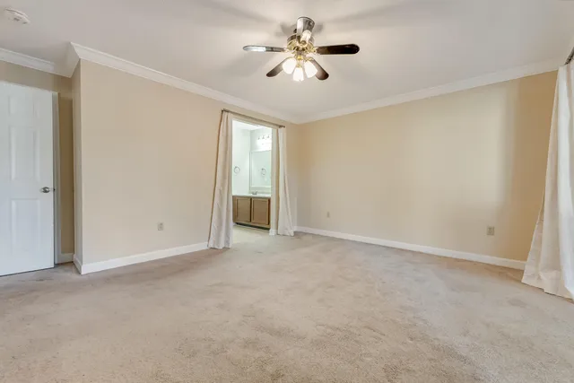 a view of an empty room and a ceiling fan