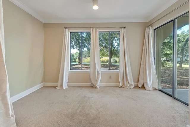 an empty room with large windows and lake view