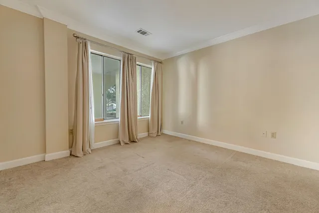 a view of empty room with windows and entryway