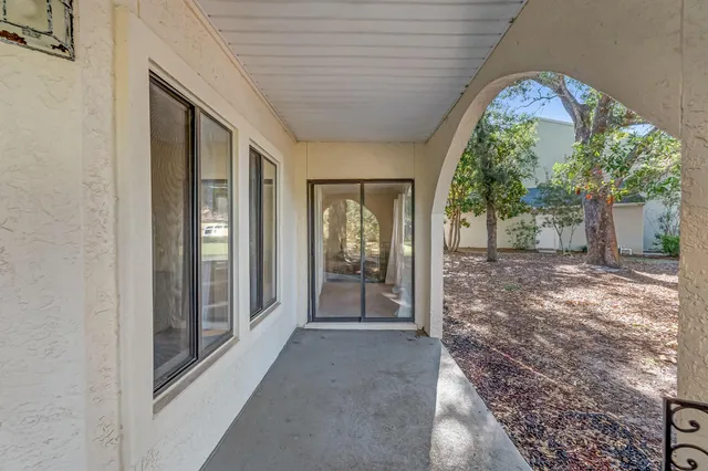 a view of a porch with a table and chairs