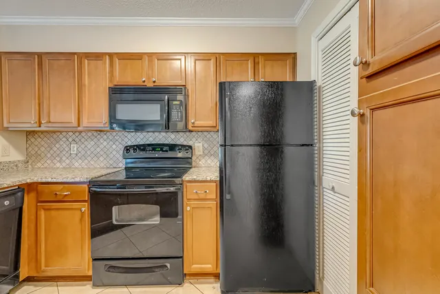 a kitchen with stainless steel appliances granite countertop a sink stove and cabinets
