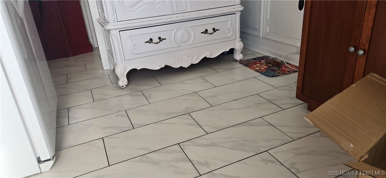 407 East Newton Street Eldon, MO 65026 - Photo 14 of 28 Marble design tile floors in kitchen and bath.