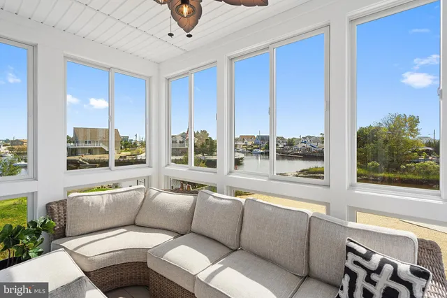 a living room with furniture and large windows