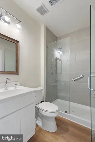 a bathroom with a toilet sink a shower and