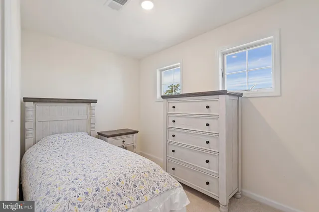 a bedroom with a bed and a dresser