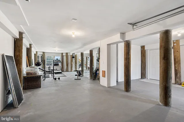 a view of a livingroom with furniture and a hallway