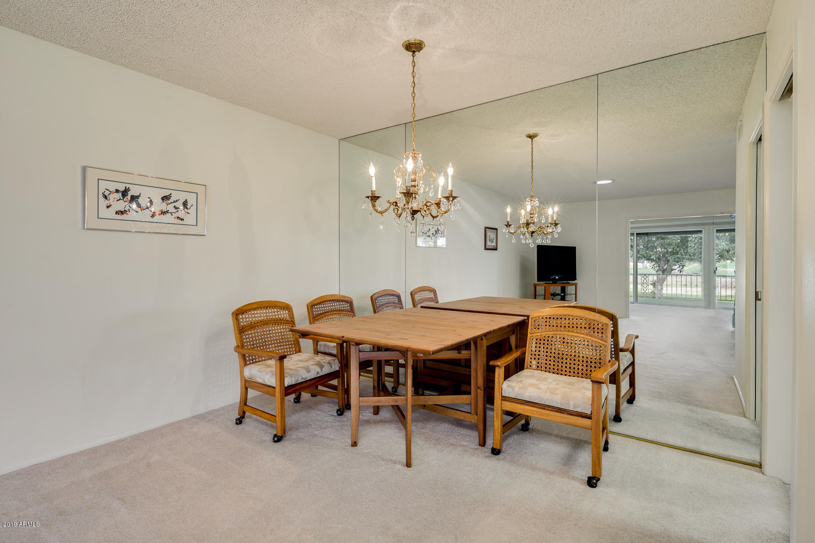 10030 West Mountain View Road Sun City, AZ 85351 - Photo 6 of 16 a view of a dining room with furniture and chandelier