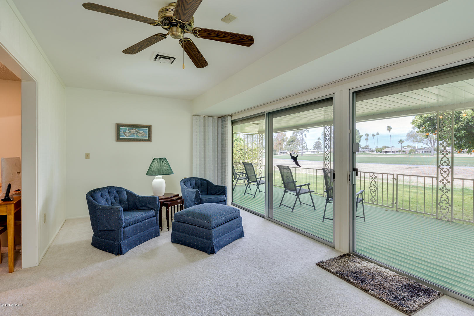 10030 West Mountain View Road Sun City, AZ 85351 - Photo 9 of 16 a living room with furniture and a floor to ceiling window