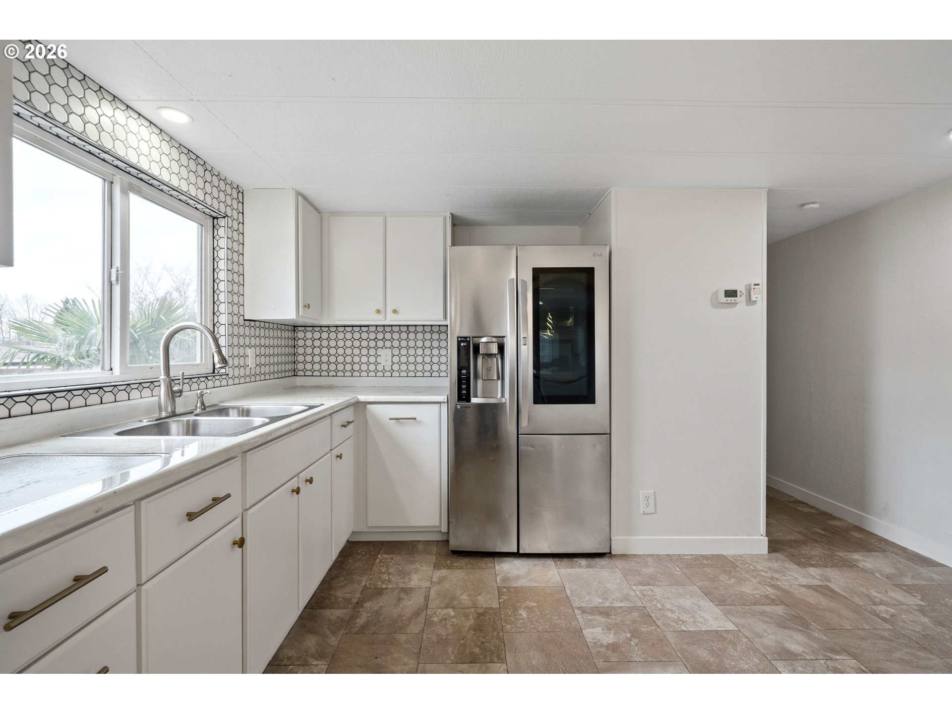 8525 Southeast Orchard Lane, Unit 91 Happy Valley, OR 97086 - Photo 14 of 35 a kitchen with a sink dishwasher a refrigerator and cabinets