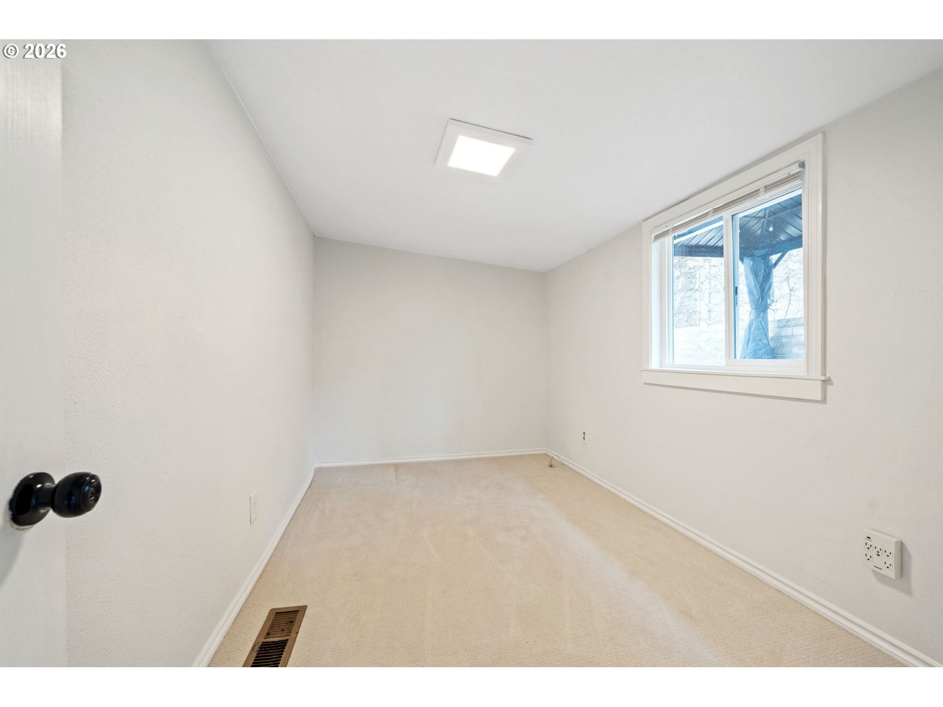 8525 Southeast Orchard Lane, Unit 91 Happy Valley, OR 97086 - Photo 16 of 35 a view of an empty room with a window