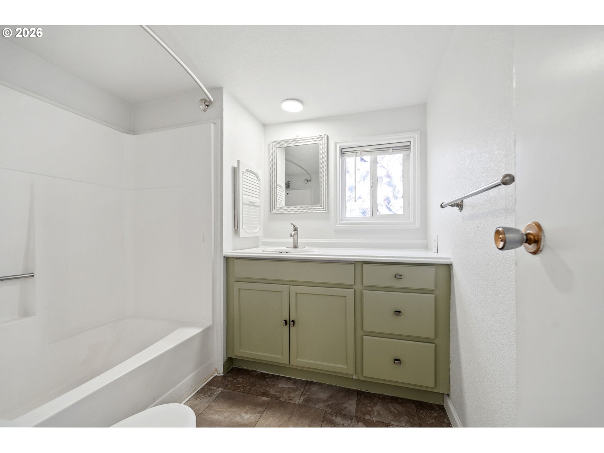 8525 Southeast Orchard Lane, Unit 91 Happy Valley, OR 97086 - Photo 23 of 35 a bathroom with a sink mirror and a bathtub