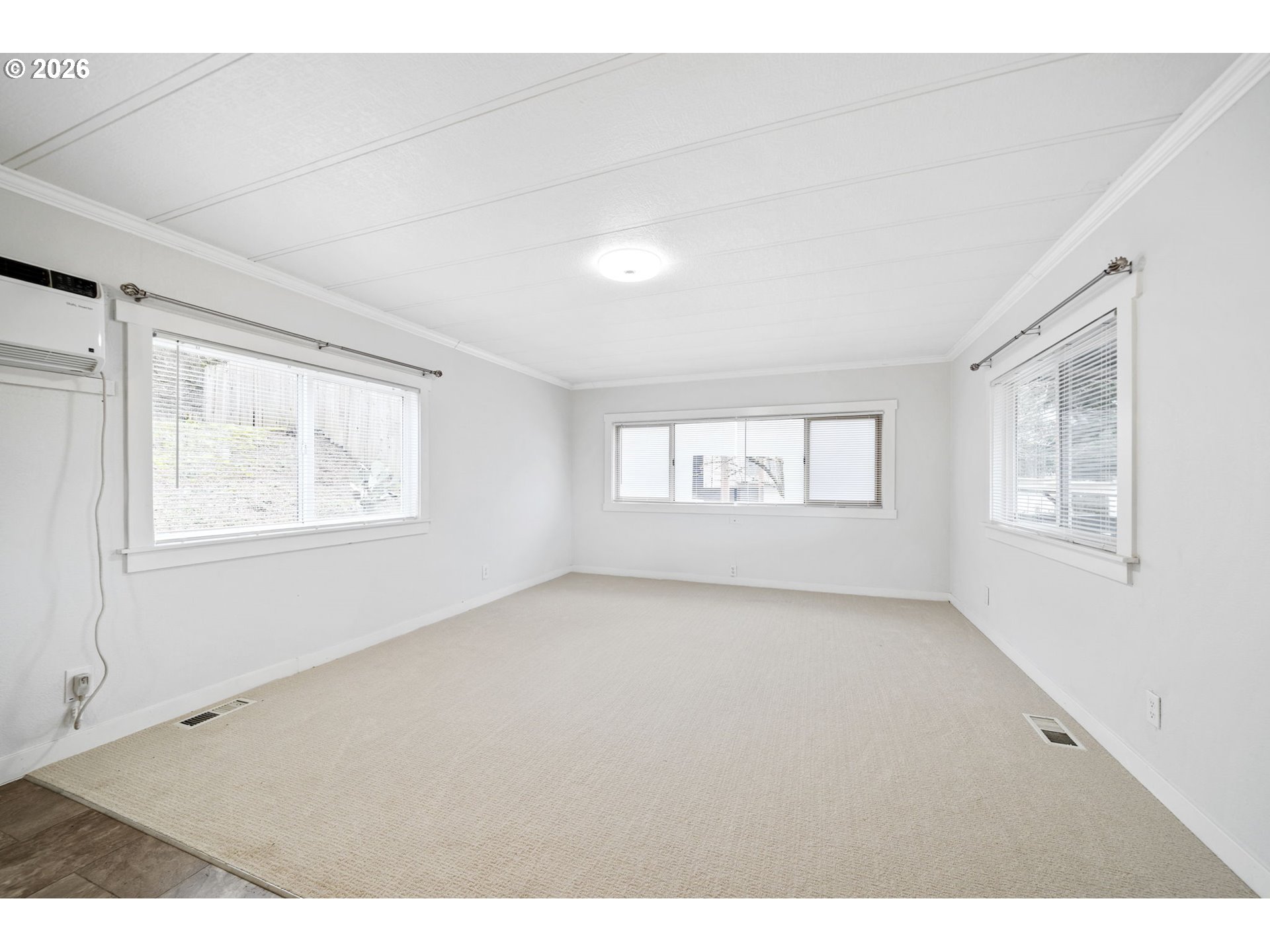 8525 Southeast Orchard Lane, Unit 91 Happy Valley, OR 97086 - Photo 6 of 35 a view of an empty room with a window