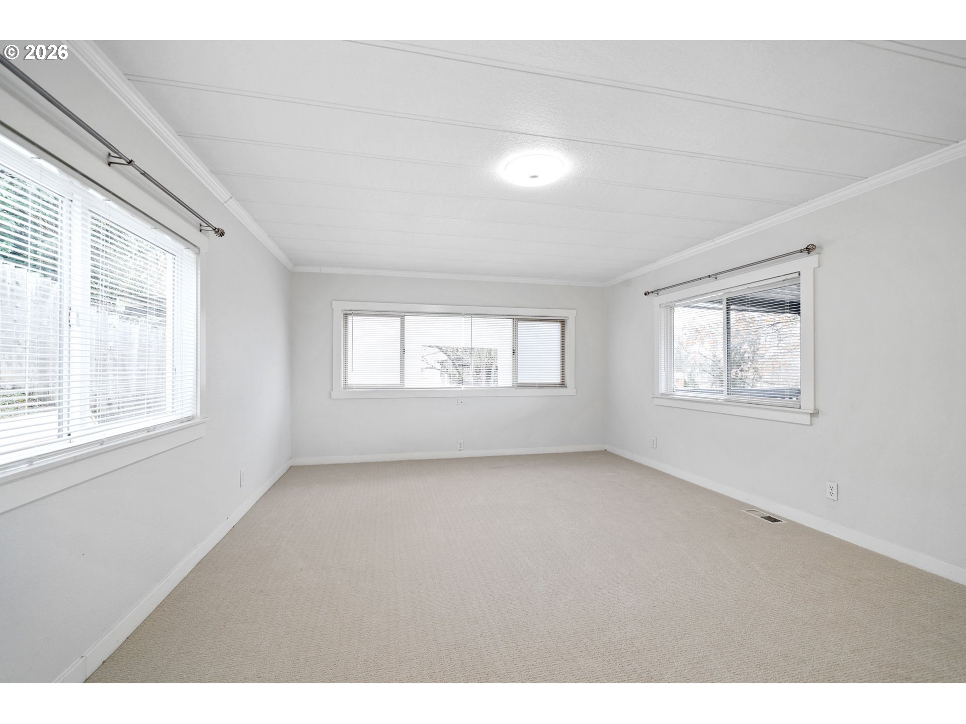 8525 Southeast Orchard Lane, Unit 91 Happy Valley, OR 97086 - Photo 7 of 35 a view of an empty room with a window