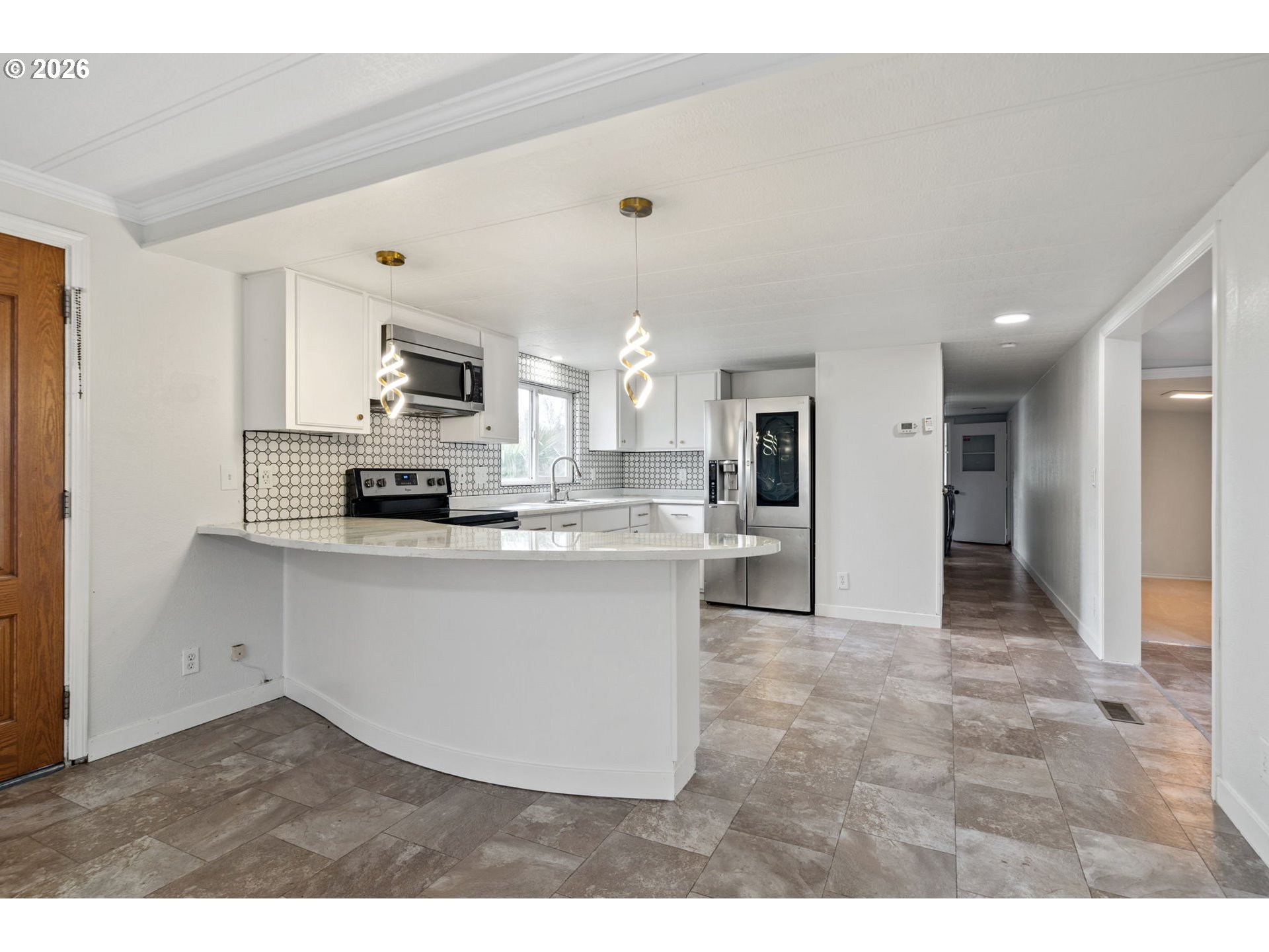 8525 Southeast Orchard Lane, Unit 91 Happy Valley, OR 97086 - Photo 10 of 35 a view of kitchen with refrigerator stove microwave and cabinets