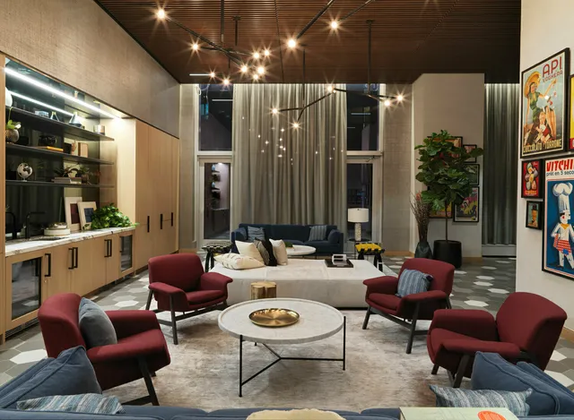 a room with stainless steel appliances granite countertop a sink a stove and a refrigerator