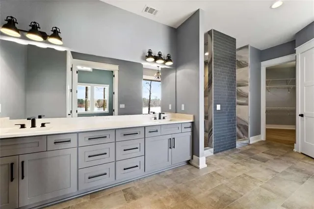 a bathroom with a glass shower door and a sink