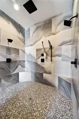 a spacious bedroom with a bed and a chandelier