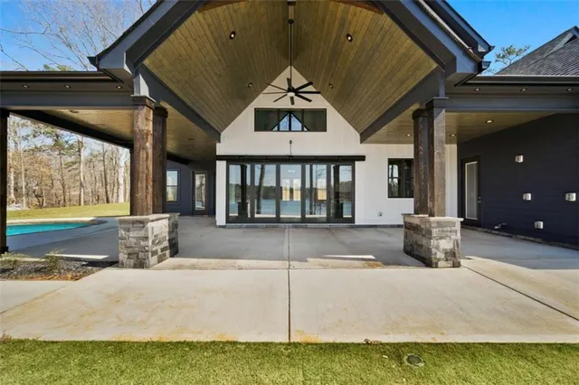 a view of a house with a big yard and large trees