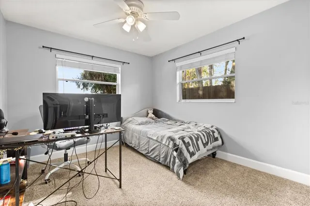 a bedroom with a bed and glass wall