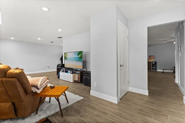 a living room with furniture and a wooden floor