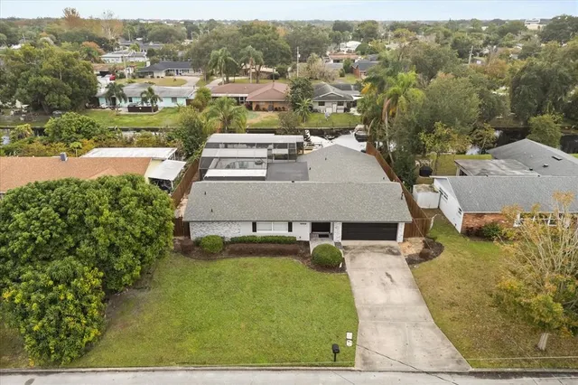 an aerial view of a house with a yard
