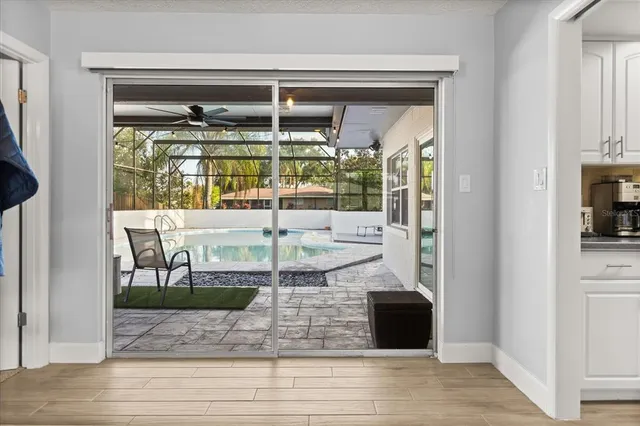 a view of a living room with a large window and fireplace
