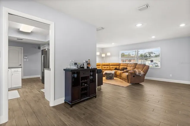 a living room with furniture and a wooden floor