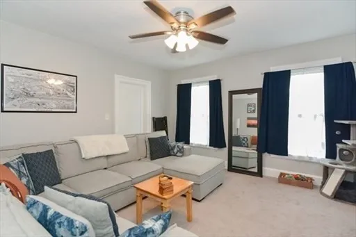 a living room with furniture and a chandelier