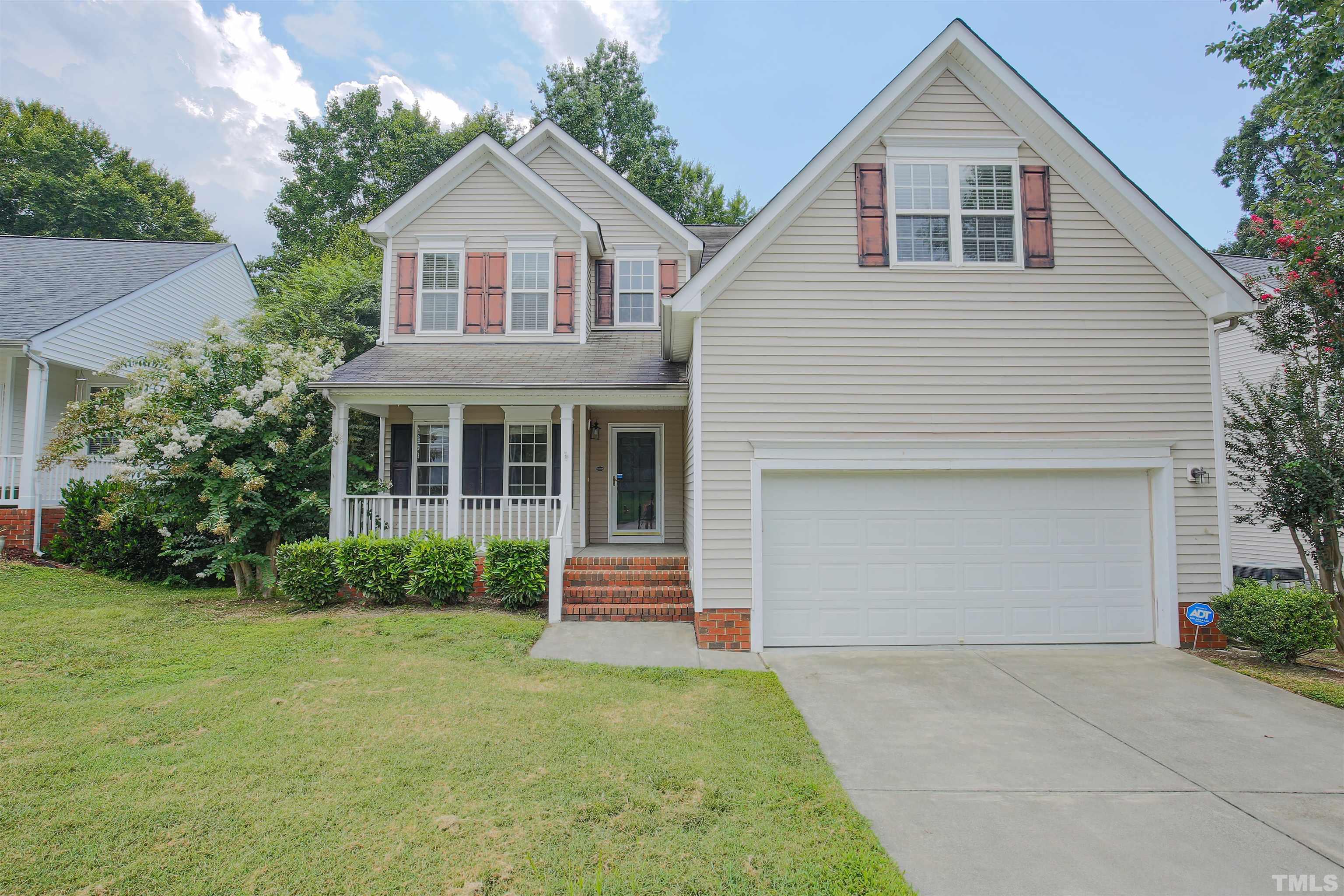 2208 Spruce Shadows Lane Raleigh, NC 27614 - Photo 1 of 26 a front view of a house with a yard and garage
