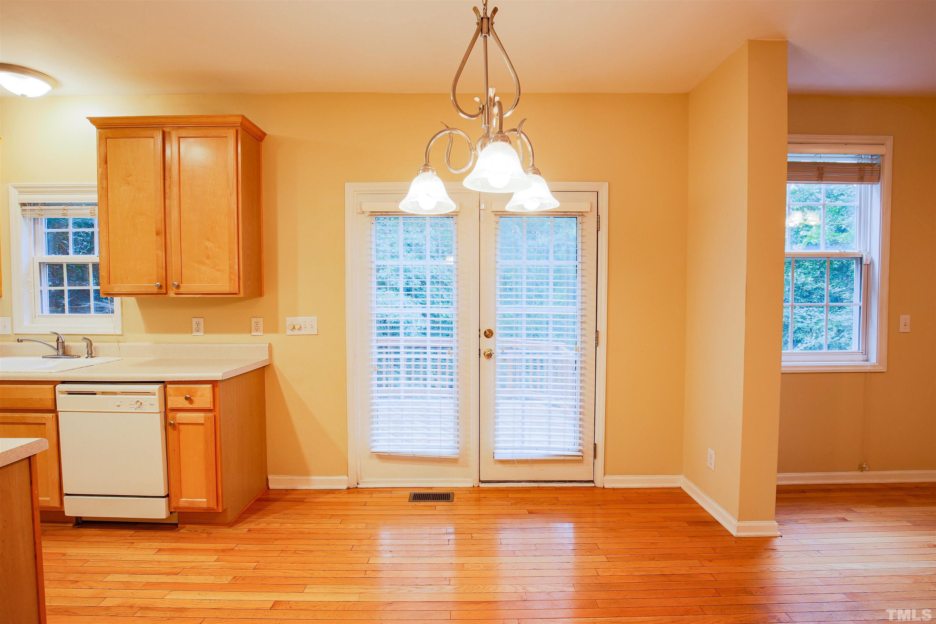 2208 Spruce Shadows Lane Raleigh, NC 27614 - Photo 12 of 26 a view of an empty room with window and wooden floor