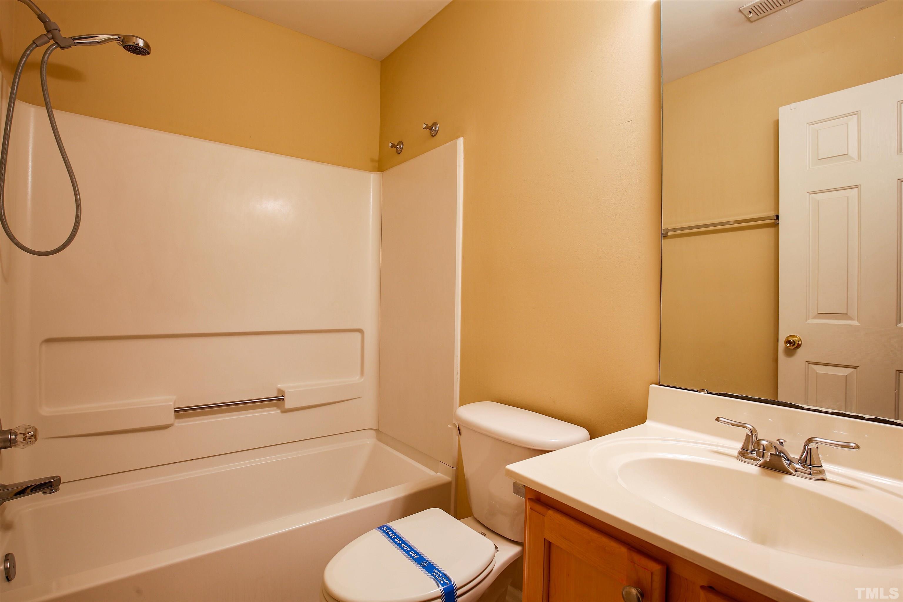 2208 Spruce Shadows Lane Raleigh, NC 27614 - Photo 16 of 26 a bathroom with a sink a toilet and shower