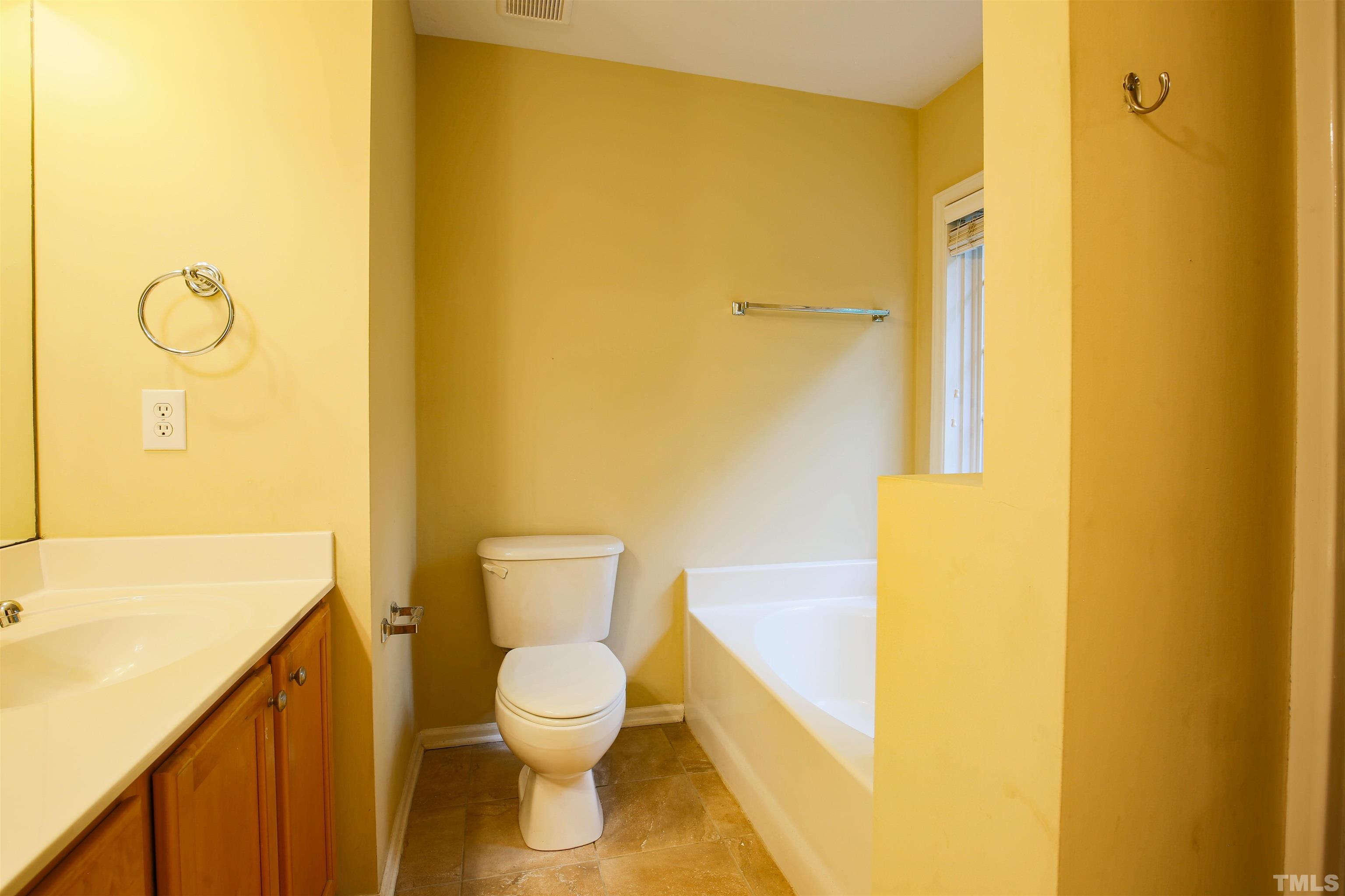 2208 Spruce Shadows Lane Raleigh, NC 27614 - Photo 17 of 26 a bathroom with a toilet sink and a shower
