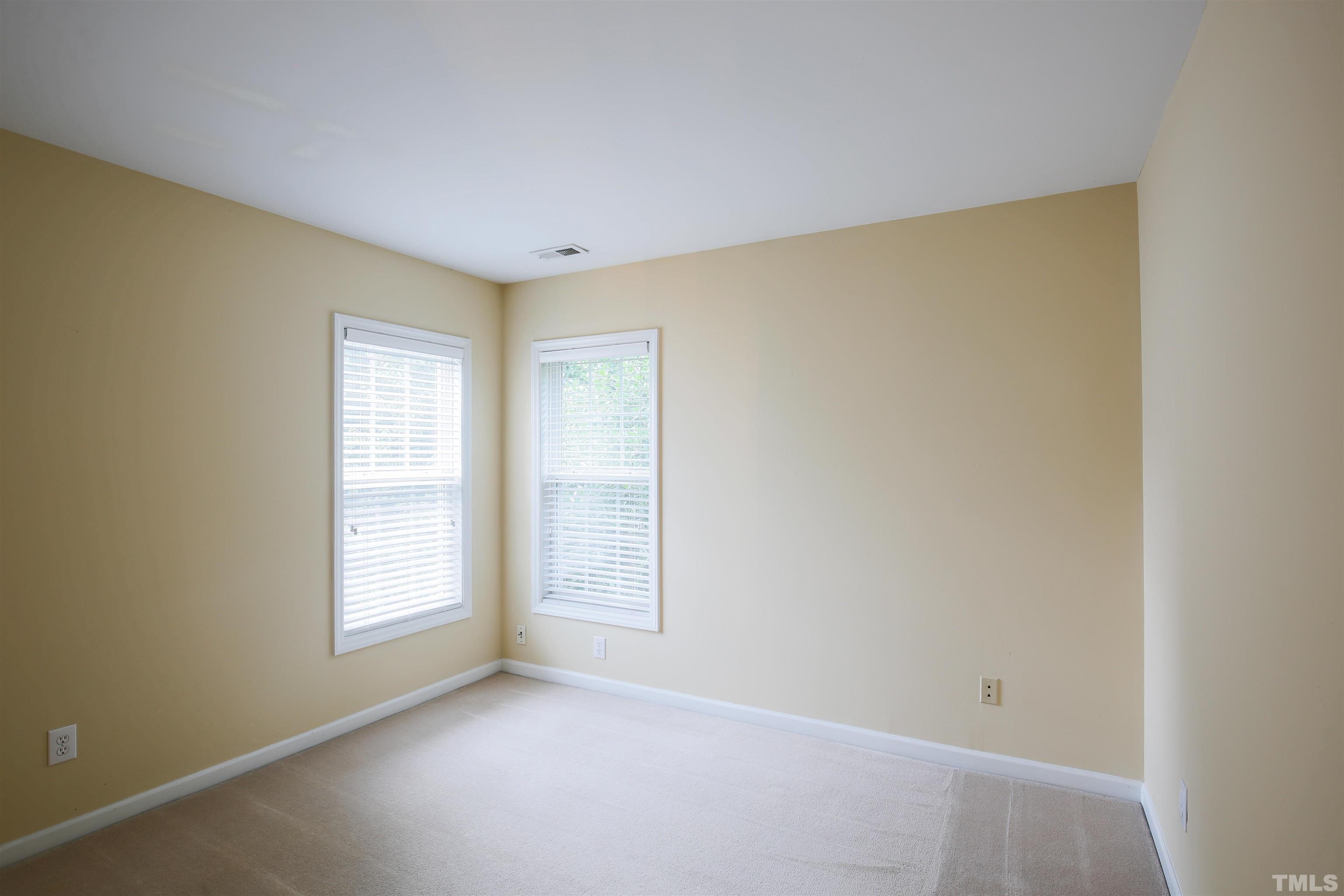 2208 Spruce Shadows Lane Raleigh, NC 27614 - Photo 20 of 26 an empty room with windows
