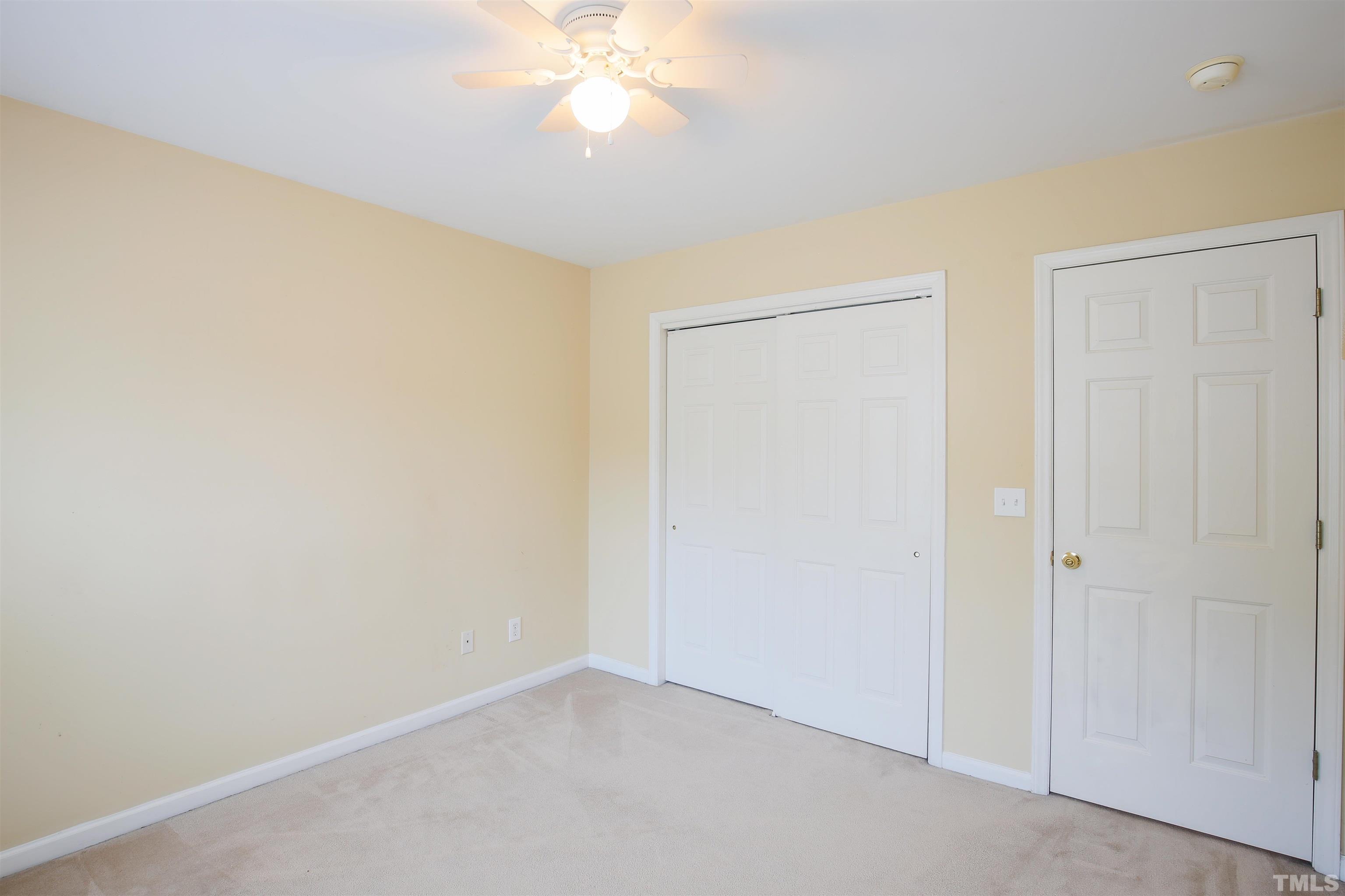 2208 Spruce Shadows Lane Raleigh, NC 27614 - Photo 23 of 26 an empty room with a chandelier fan