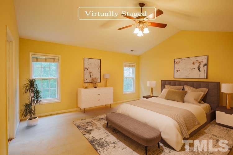 2208 Spruce Shadows Lane Raleigh, NC 27614 - Photo 3 of 26 a bedroom with a bed and a chandelier