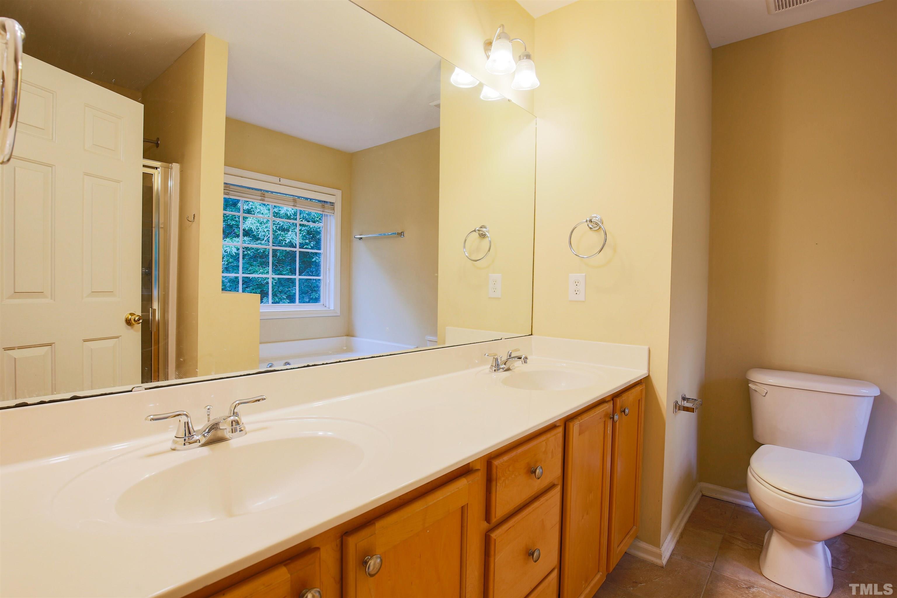 2208 Spruce Shadows Lane Raleigh, NC 27614 - Photo 6 of 26 a bathroom with a sink a toilet and shower