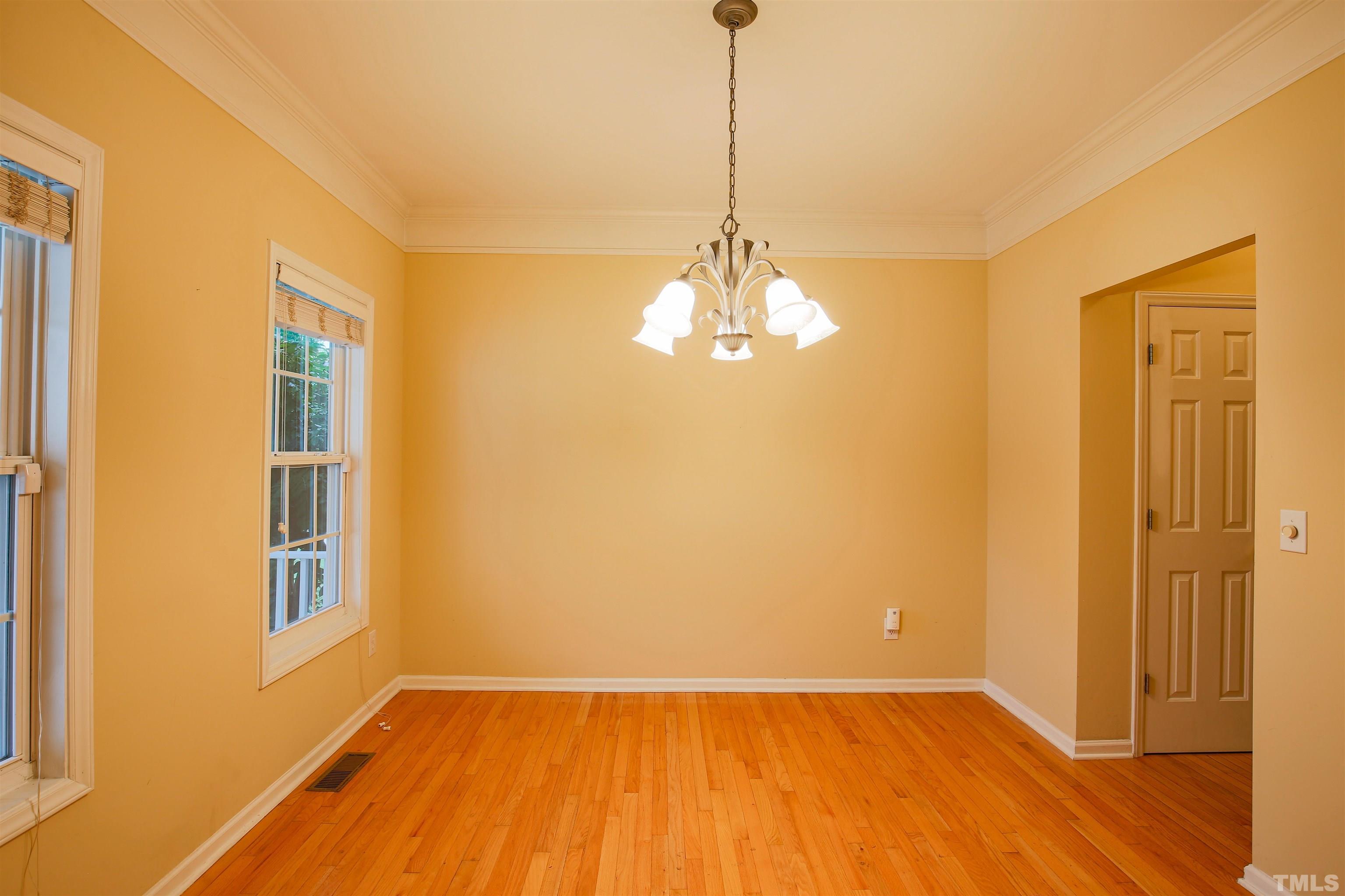 2208 Spruce Shadows Lane Raleigh, NC 27614 - Photo 10 of 26 a view of an empty room with chandelier and a window