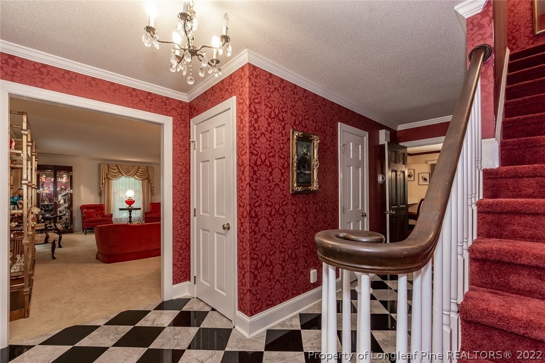 503 Queensferry Road Cary, NC 27511 - Photo 22 of 49 a view of a hallway with furniture and chandelier