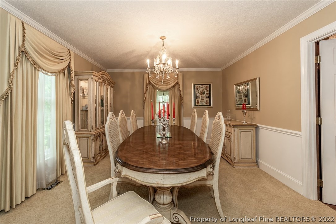 503 Queensferry Road Cary, NC 27511 - Photo 26 of 49 a view of a dining room with furniture and chandelier