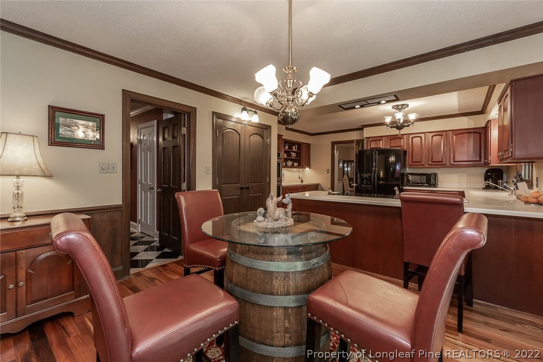 503 Queensferry Road Cary, NC 27511 - Photo 28 of 49 a view of a dining room with furniture a chandelier and wooden floor