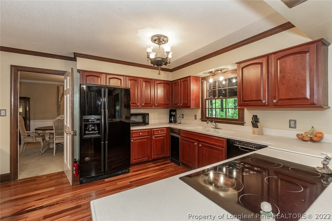 503 Queensferry Road Cary, NC 27511 - Photo 29 of 49 a kitchen with stainless steel appliances granite countertop a sink refrigerator and cabinets