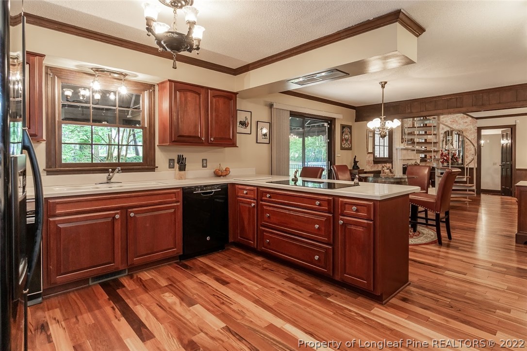 503 Queensferry Road Cary, NC 27511 - Photo 31 of 49 a kitchen with a sink stove and wooden cabinets