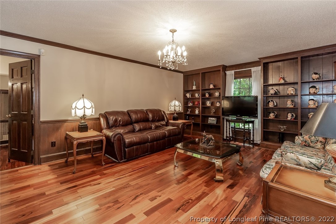 503 Queensferry Road Cary, NC 27511 - Photo 33 of 49 a living room with furniture a lamp and a chandelier