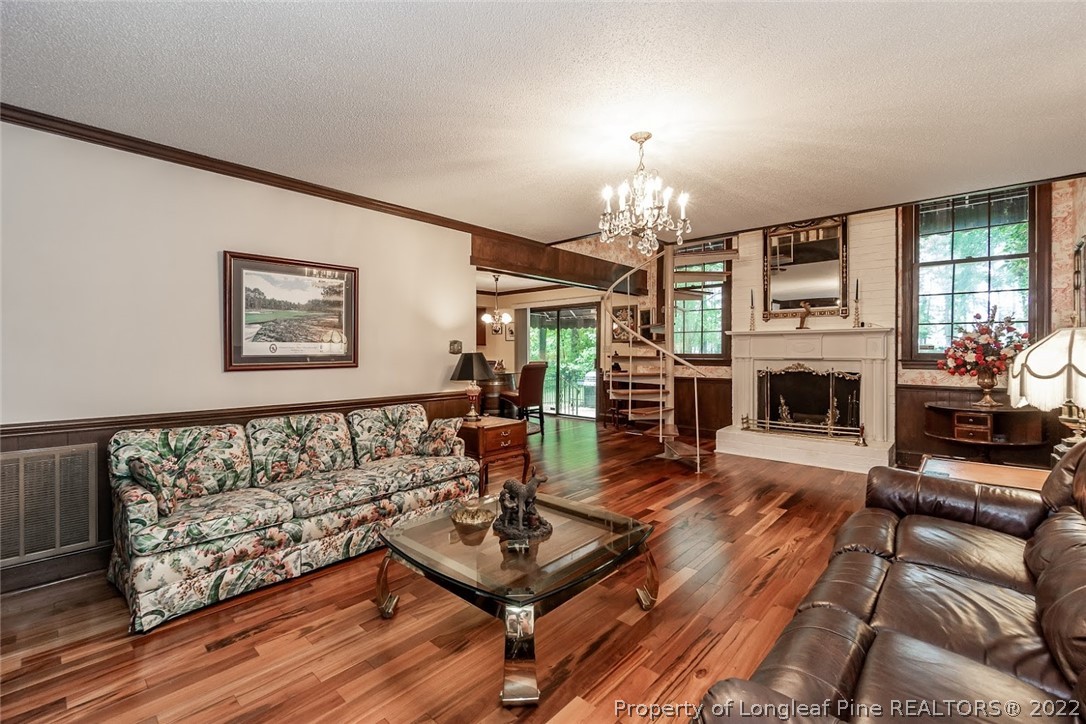503 Queensferry Road Cary, NC 27511 - Photo 34 of 49 a living room with furniture a fireplace and a flat screen tv