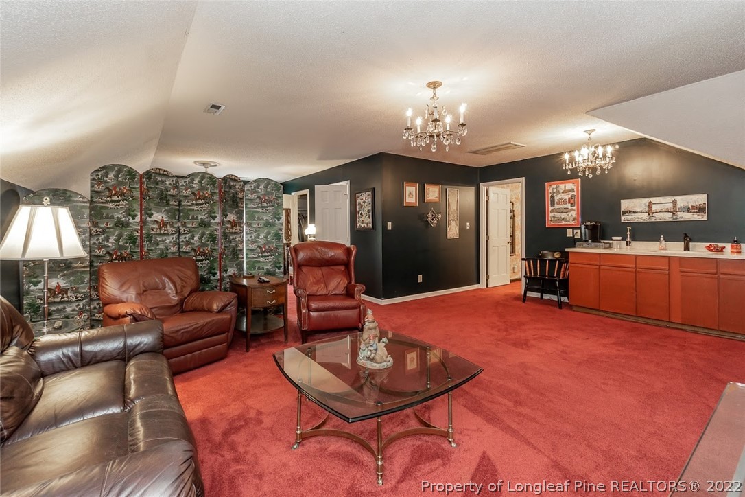 503 Queensferry Road Cary, NC 27511 - Photo 40 of 49 a living room with furniture a chandelier and a dining room