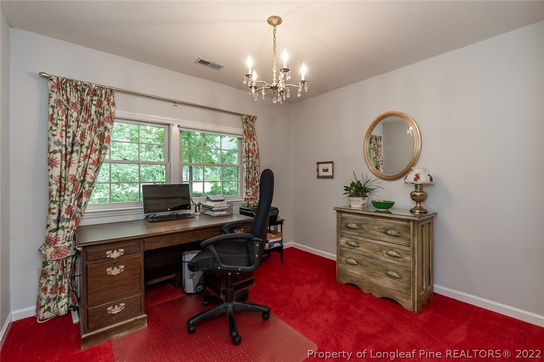 503 Queensferry Road Cary, NC 27511 - Photo 46 of 49 a view of a workspace with furniture and a chandelier