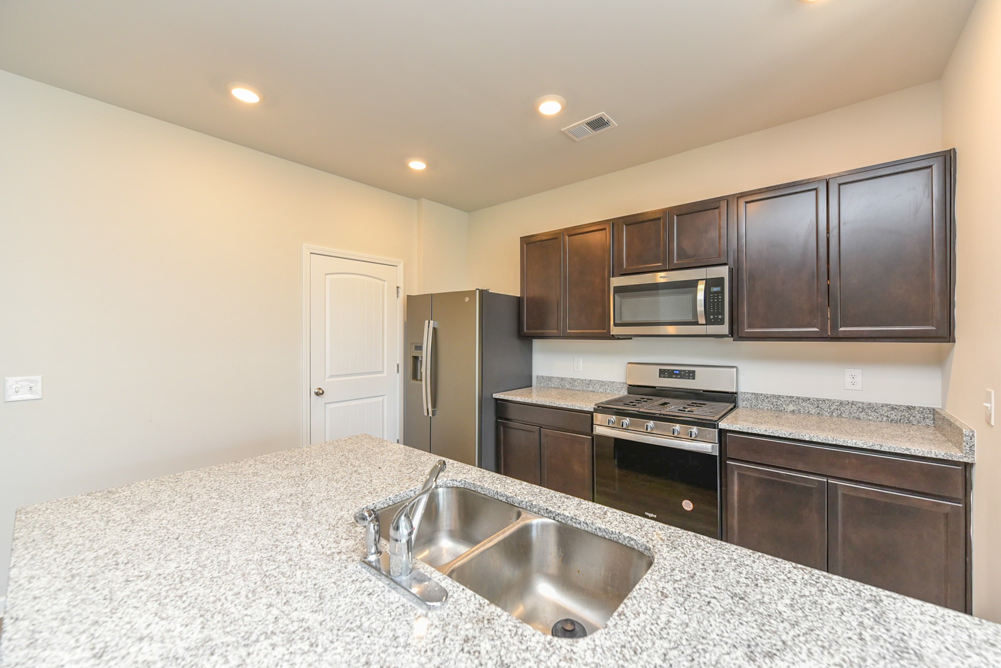 630 Pine Bloom Road Lebanon, TN 37087 - Photo 12 of 44 a kitchen with stainless steel appliances granite countertop a sink stove and refrigerator