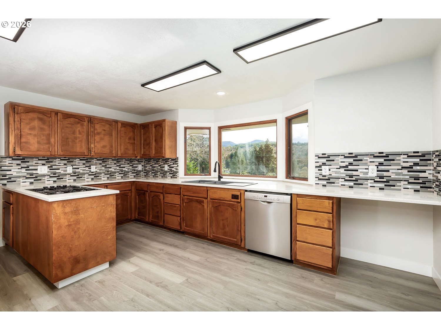 48187 McFarland Road Oakridge, OR 97463 - Photo 20 of 41 a kitchen with stainless steel appliances kitchen island granite countertop a stove a sink and a refrigerator
