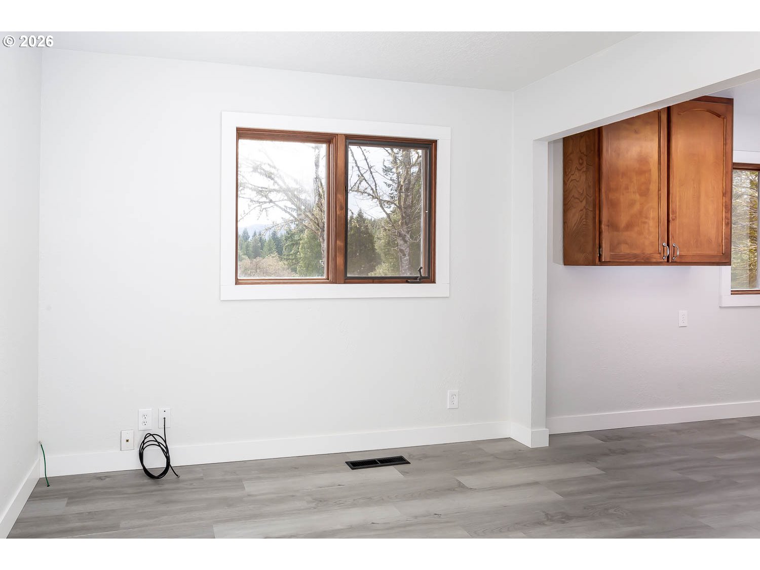 48187 McFarland Road Oakridge, OR 97463 - Photo 23 of 41 a view of an empty room with wooden floor and windows