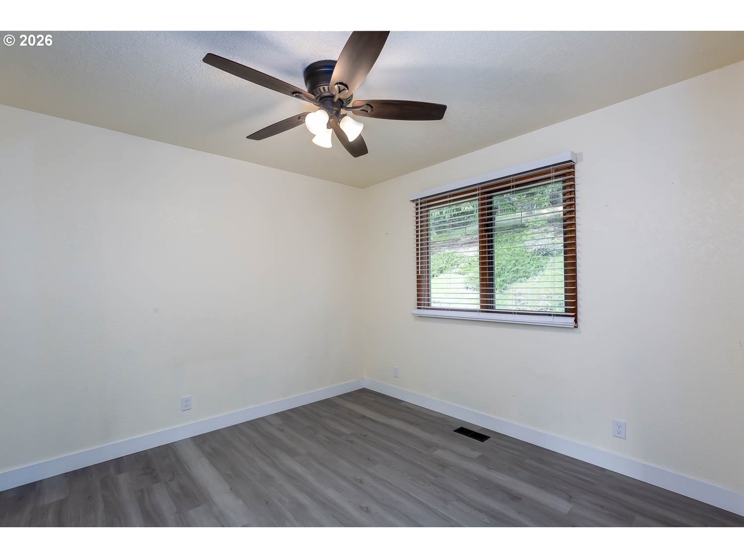 48187 McFarland Road Oakridge, OR 97463 - Photo 27 of 41 a view of an empty room with wooden floor and a window